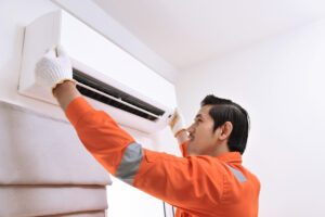 A professional technician repairing the Ac unit