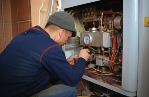 A technician repairing Furnace system